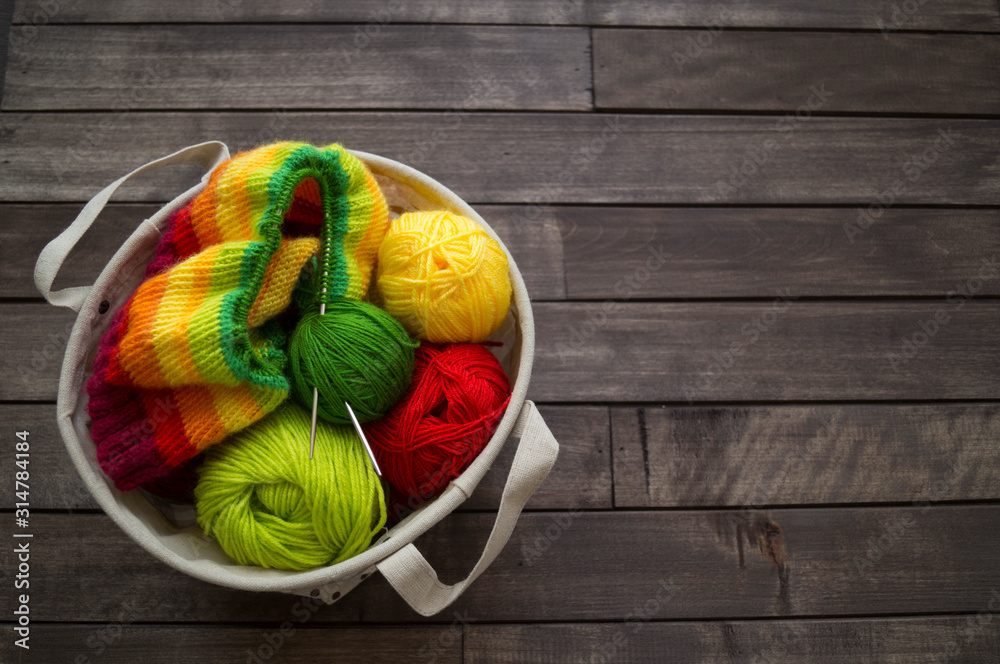 Yarn for knitting rainbow. Wood background. - obrazy, fototapety, plakaty 