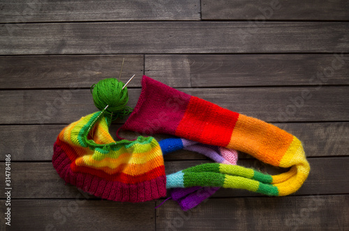 Yarn for knitting rainbow. Wood background.