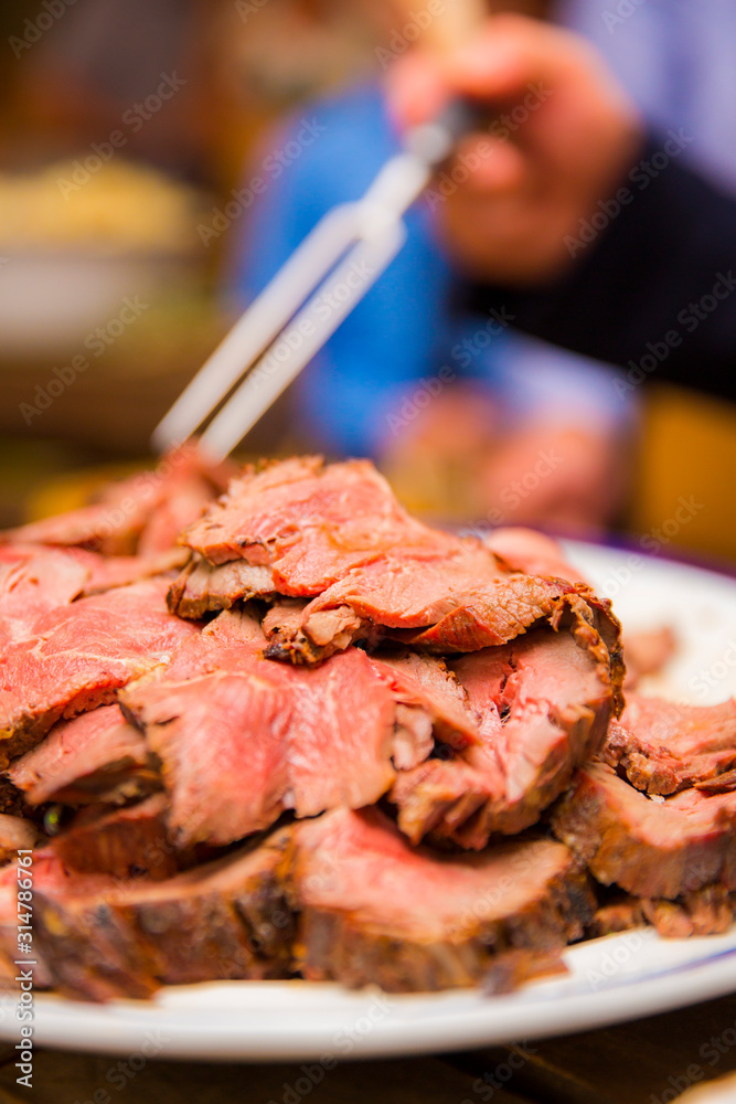 Juicy red meat cooked and served at a buffet