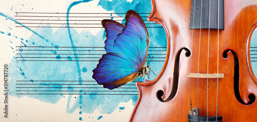 Butterfly, violin and notes. Blue morpho butterfly and violin. Melody concept. Photo of old music sheet in blue watercolor paint. Classical music concept. Violin close up. copy spaces