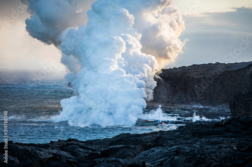 Lava pouring into the sea causing steam clouds