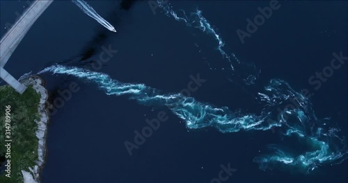 4K Boat crossing Saltstraumen current tide vortex. Bird's eye view drone footage