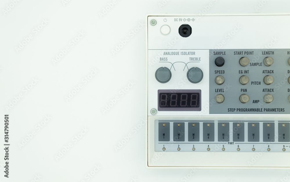 White analog synthesizer sampler with knobs and keys. Audio equipment for musical production. Drum machine. White background. Music concept. White analog synthesizer sampler with knobs and keys. Audio equipment for musical production. Drum machine. White background. Music concept.