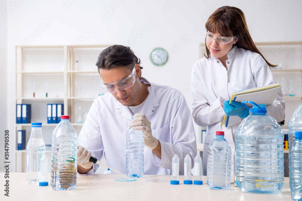 Two chemists working in the lab Two chemists working in the lab