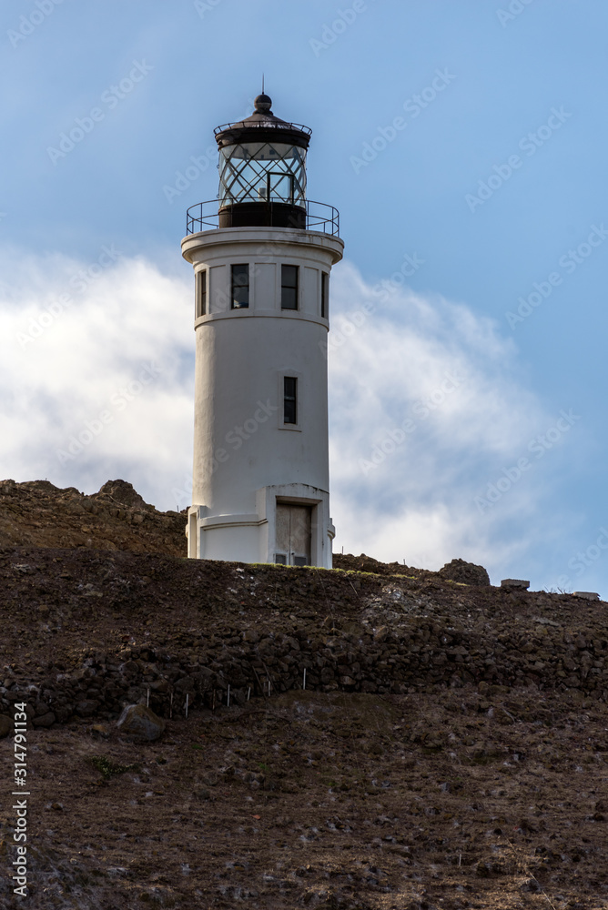 Anacapa Island Ranger lighthouse stands tall on top of the volcanic rock cliff to provide safety for sea vessels.