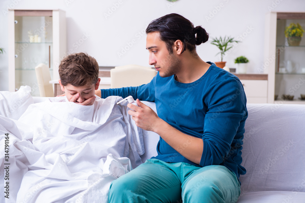 Fototapeta premium Young father caring for sick son