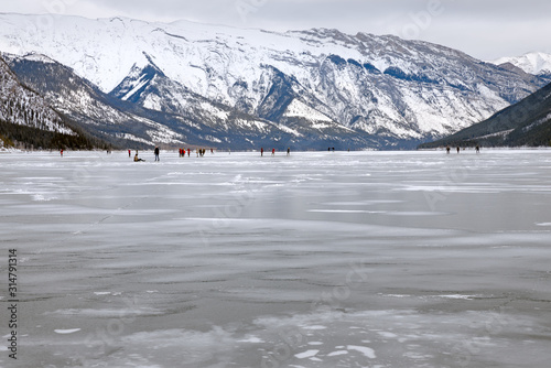Ice skating on Lake Minnewanka in Banff National Park  Alberta  Canada