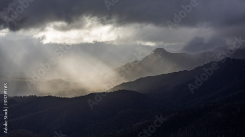 Fototapeta Naklejka Na Ścianę i Meble -  Heavenly light over dramatic mountains in Tasmania, Australia