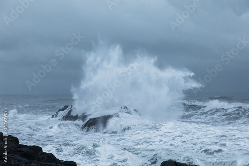 Wave crashing over rocks in Iceland coast