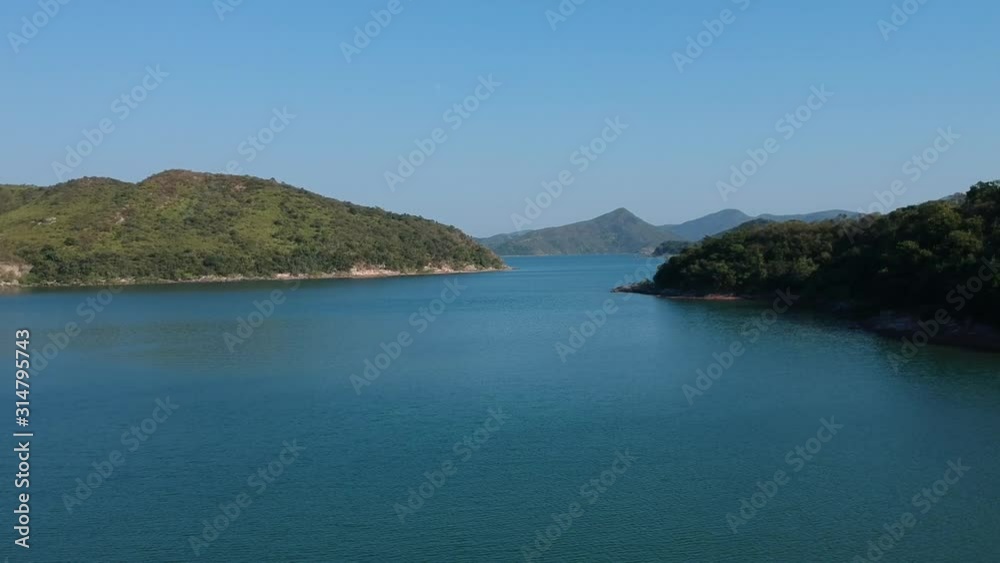 Drone Flyover of Reservoir in Hong Kong, Island Coastline in Background Drone Flyover of Reservoir in Hong Kong, Island Coastline in Background