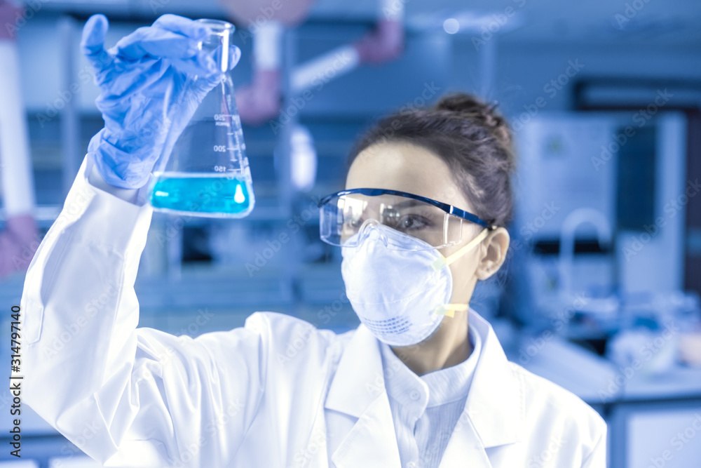 Female scientist looking at the scientific sample in the CDC laboratory. Female scientist looking at the scientific sample in the CDC laboratory.