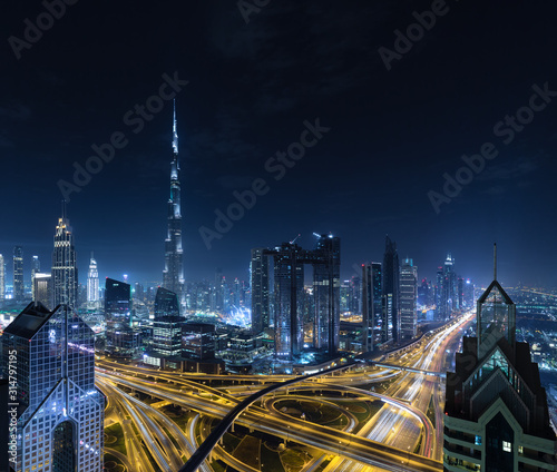 Photography Modern city skyline and cityscape at night in Dubai UAE.