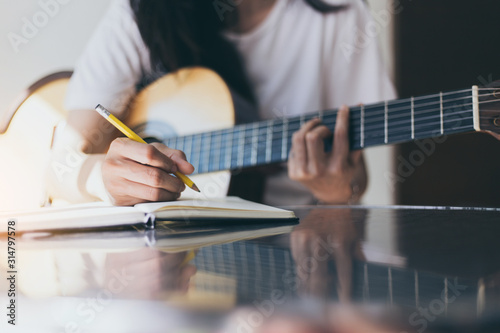 Fotografie artist songwriter thinking writing notes,lyrics in book at studio