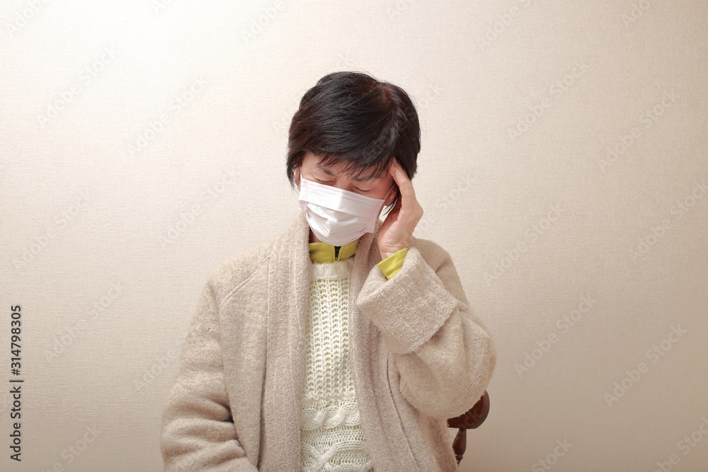 middle aged woman wearing a mask and catching a cold