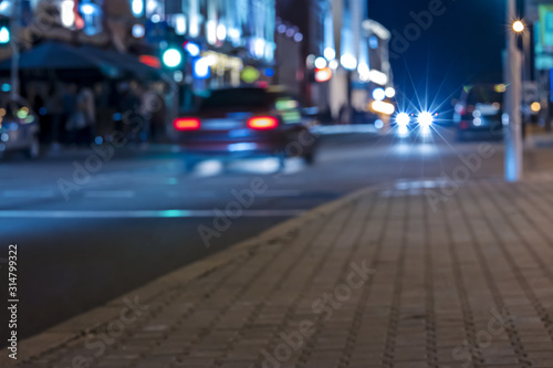 city street at night. blurred view of cars in motion with lights