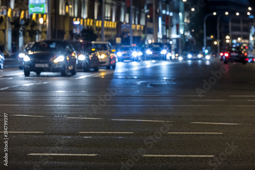 colorful lights of car traffic at night. city street with driving cars. motion blur