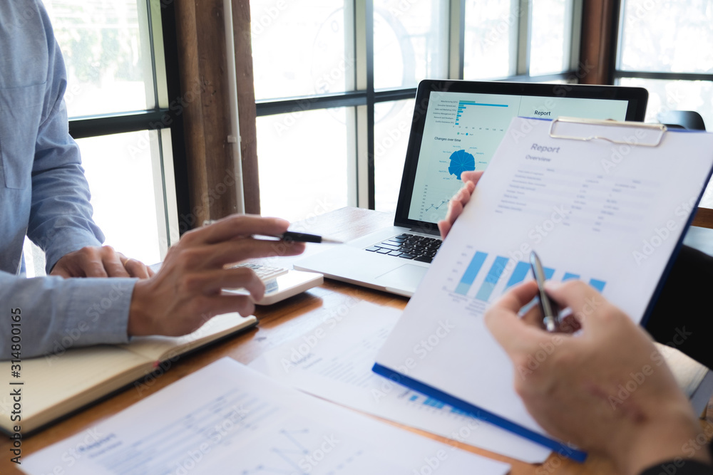 Sitting and working, consulting and suggesting work, checking work reports with a calculator in a business office. Sitting and working, consulting and suggesting work, checking work reports with a calculator in a business office.