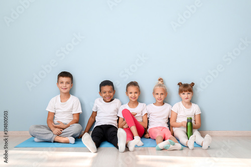 Little children with yoga m...