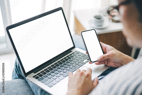 mockup image blank screen computer,cell phone with white background for advertising text,hand woman using laptop texting mobile contact business search information on desk in office.marketing,design
