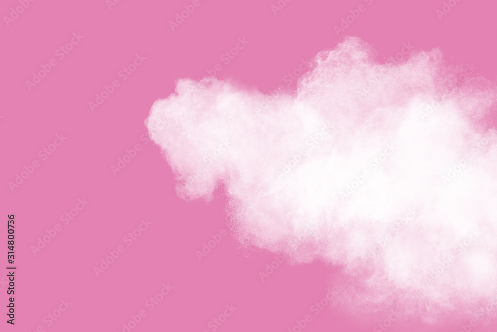 White powder explosion on pink background.