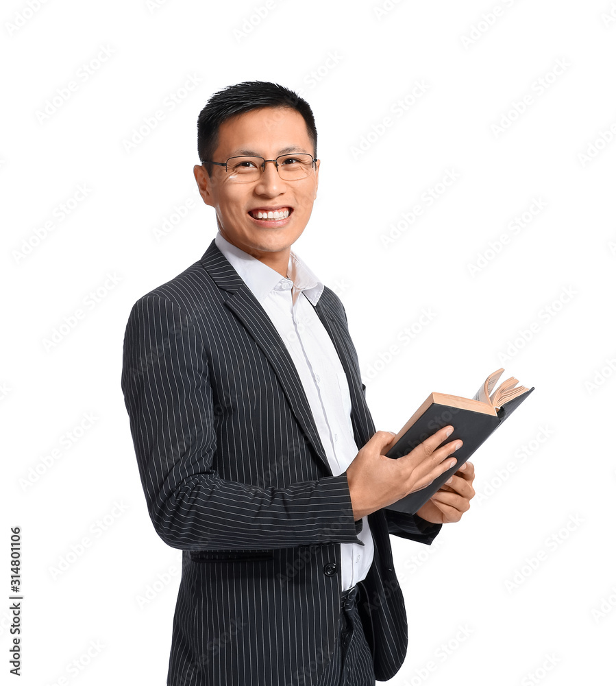 Handsome Asian businessman with book on white background Handsome Asian businessman with book on white background