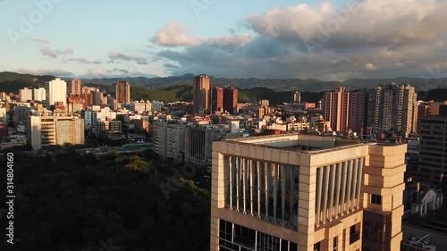 Drone Aerial View of Taiwan Capital, Taipei Under Sunset Sunlight, Daan Park and Modern Residental Buildings photo