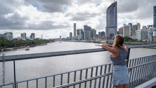 Young woman looking at the skyline of Brisbane in Australia