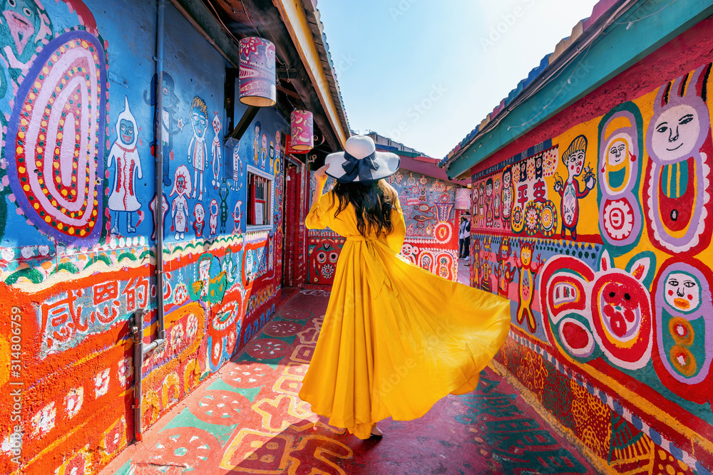 Woman standing at Rainbow village in Taichung, Taiwan. - obrazy, fototapety, plakaty 