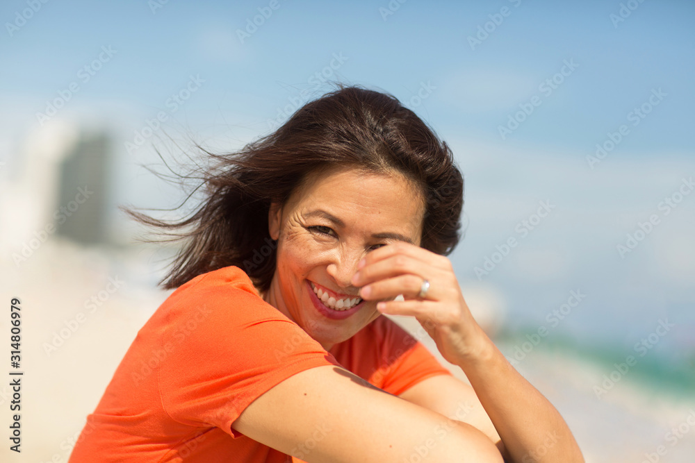 Portrait of a happy confident Asian woman smiling.