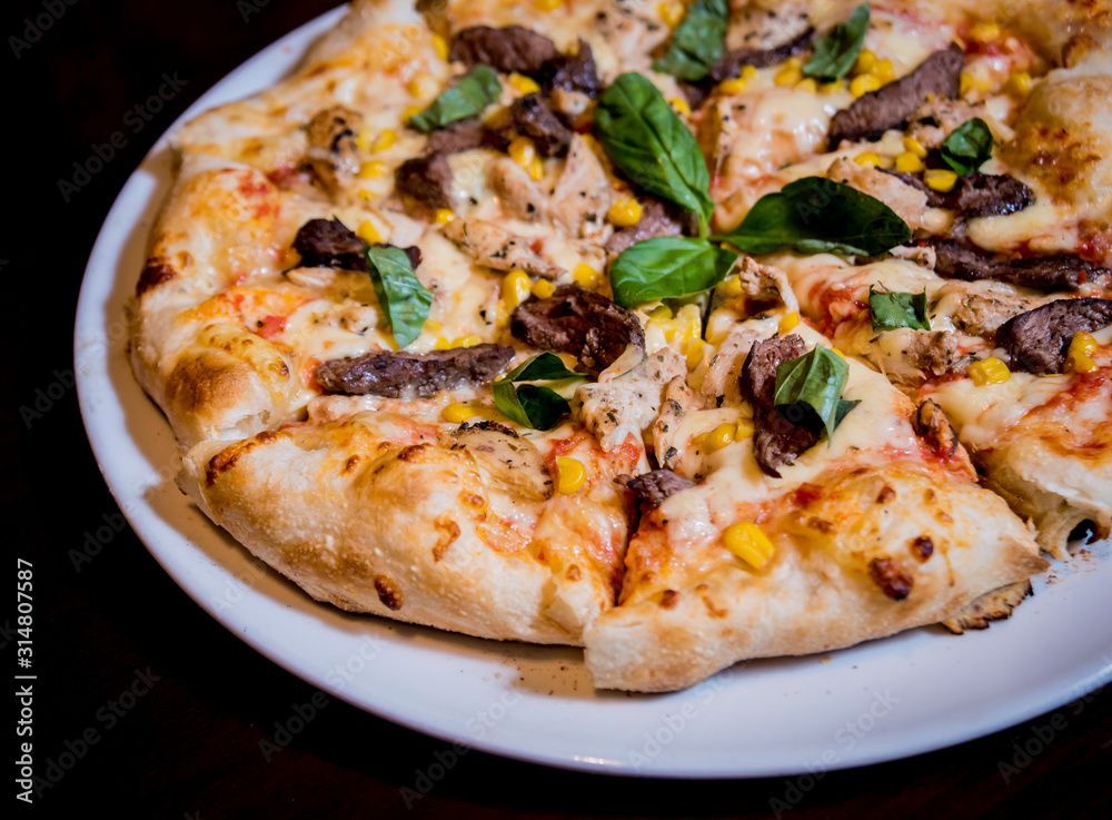 Tasty pizza with chicken and vegetables. Restaurant.