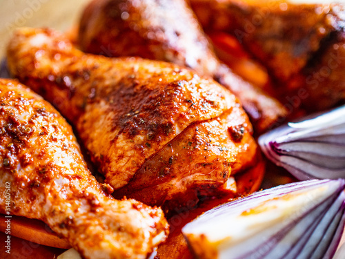 Marinated raw chicken drumsticks ready to roast