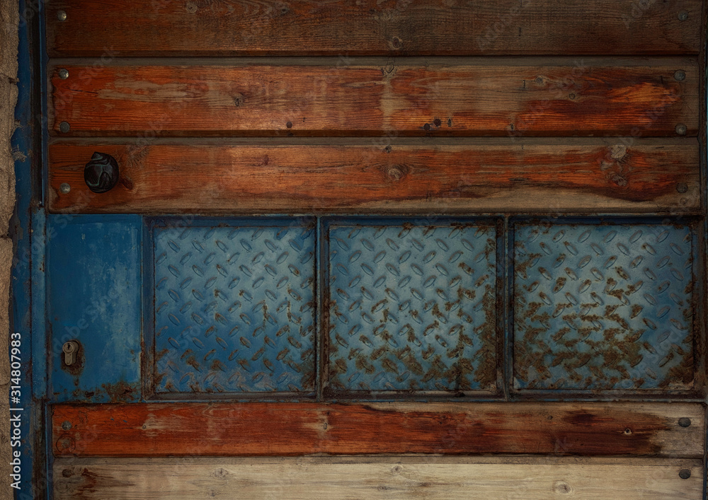 Old wooden door with glass details. Architectural background. Grunge textures