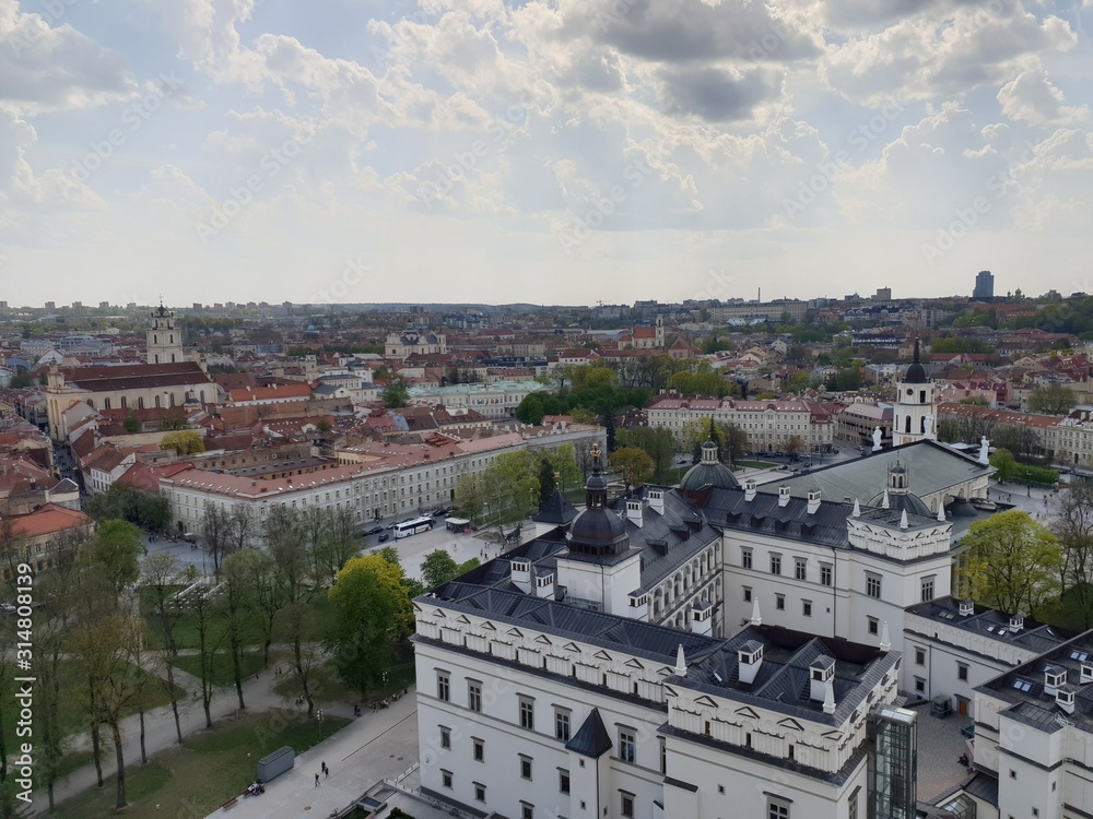 Panoramic view of the colorful forest and urban roofs of houses against a blue sky. Vilnius. Lithuania