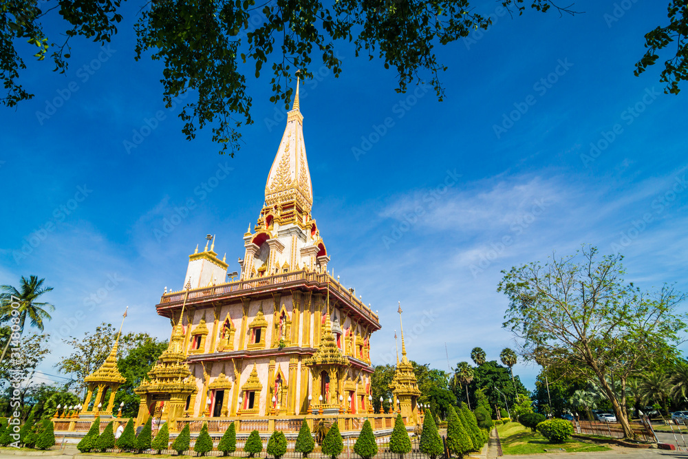 Naklejka premium Chalong buddhist temple against blue sky in Phuket Thailand