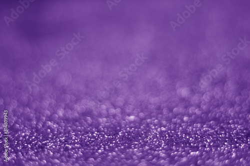 Purple abstract glittering protons caused by blurred objects