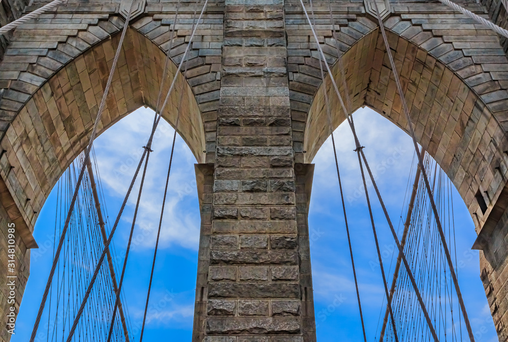 Fototapeta premium Closeup of the pointed arches above the passageways through the stone towers of the Brooklyn bridge in New York City USA