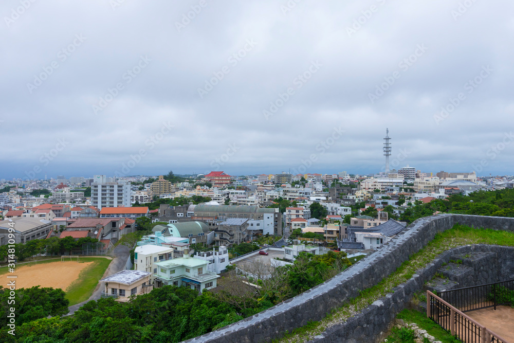 View at the top of Shuri Castle rampart overlooking Okinawa skyline in Naha, Okinawa, Japan 