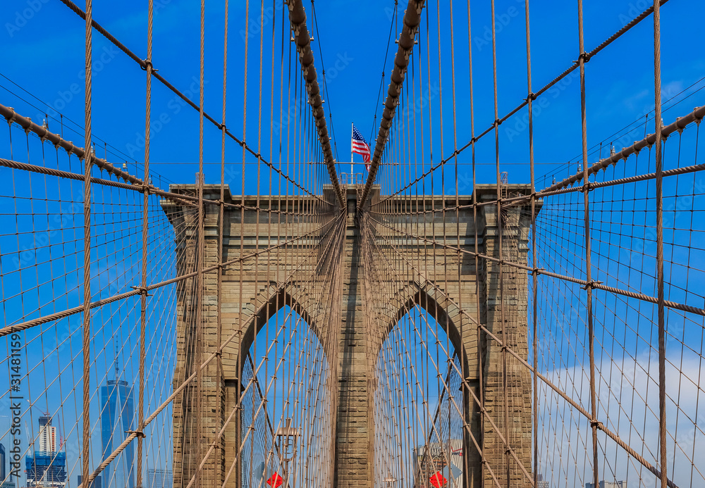 Obraz premium Closeup of the pointed arches above the passageways through the stone towers of the Brooklyn bridge in New York City USA