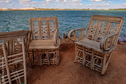 Siwa Oasis, Egypt Sun chairs along the side of Lake Aftnas. photo