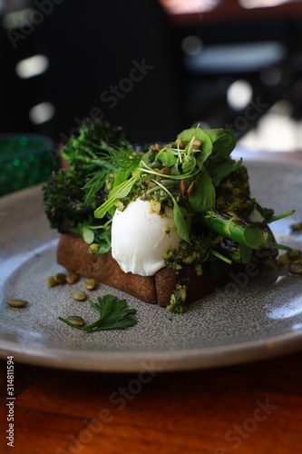 Organic Green Vegetables and Herbs served on Rye Toasted Sourdough with Poached Eggs, Pesto and Roasted Pumpkin Seeds