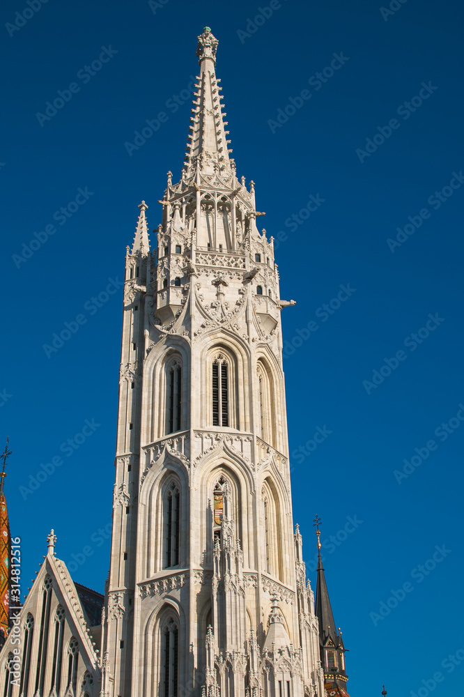 Bell tower of Matthias Church, a Roman Catholic church in front of theFisherman's Bastion at the heart of Buda's Castle District