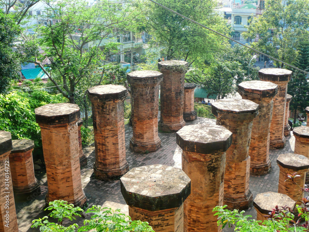 Fototapeta premium Old stone columns from the temple of Vietnam on a summer sunny day