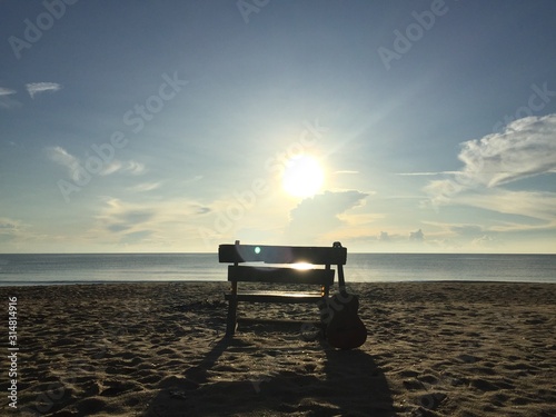 Romantic seaside chair and guitar 