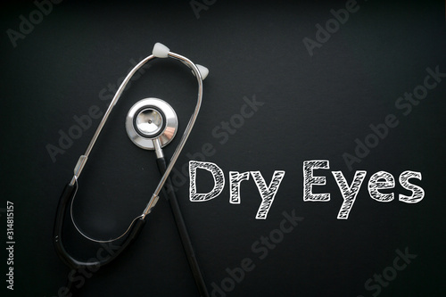 Medical Concept-Dry Eyes words written on black background with Stethoscope