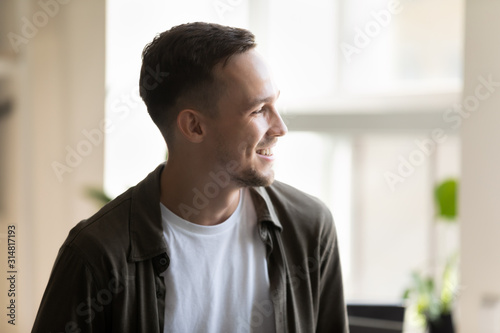 Headshot portrait of millennial successful entrepreneur young businessman posing indoors