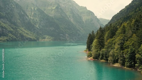 Turquoise river water landscape on a sunny day. Aerial pan left