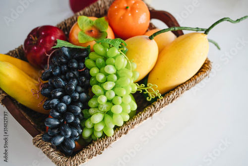 Obraz na plátně basket with fresh fruit and juice on white modern office table