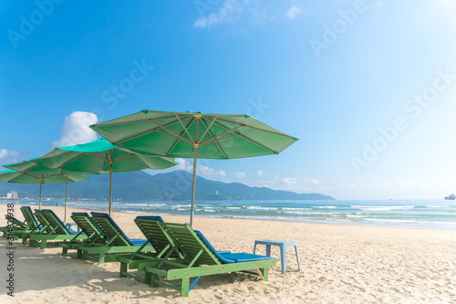 Beach chairs with outdoor umbella at summer beach.