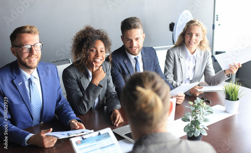 Job interview with the employer, businessman listen to candidate answers. photo