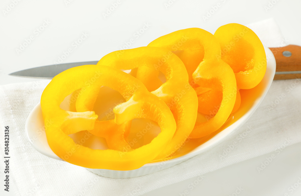 Yellow bell pepper slices in bowl Yellow bell pepper slices in bowl